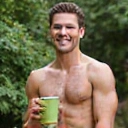 A fit man in his 40s, possibly exercising or holding a healthy snack.